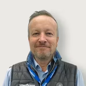 A member of staff, Barry Abbott in a blue shirt and a Lowdhams lanyard