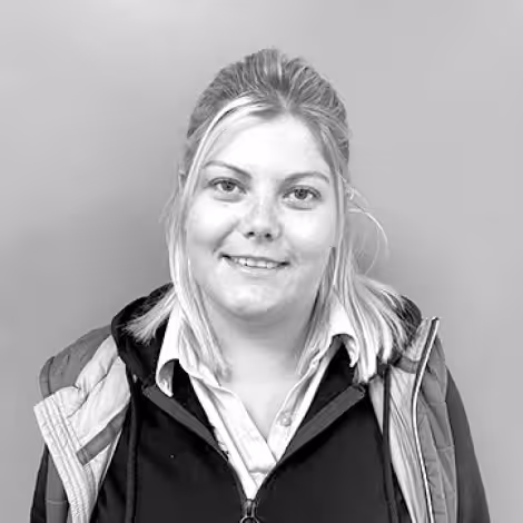 A black and white photo of Jenny, a blonde woman wearing a Lowdhams employee uniform